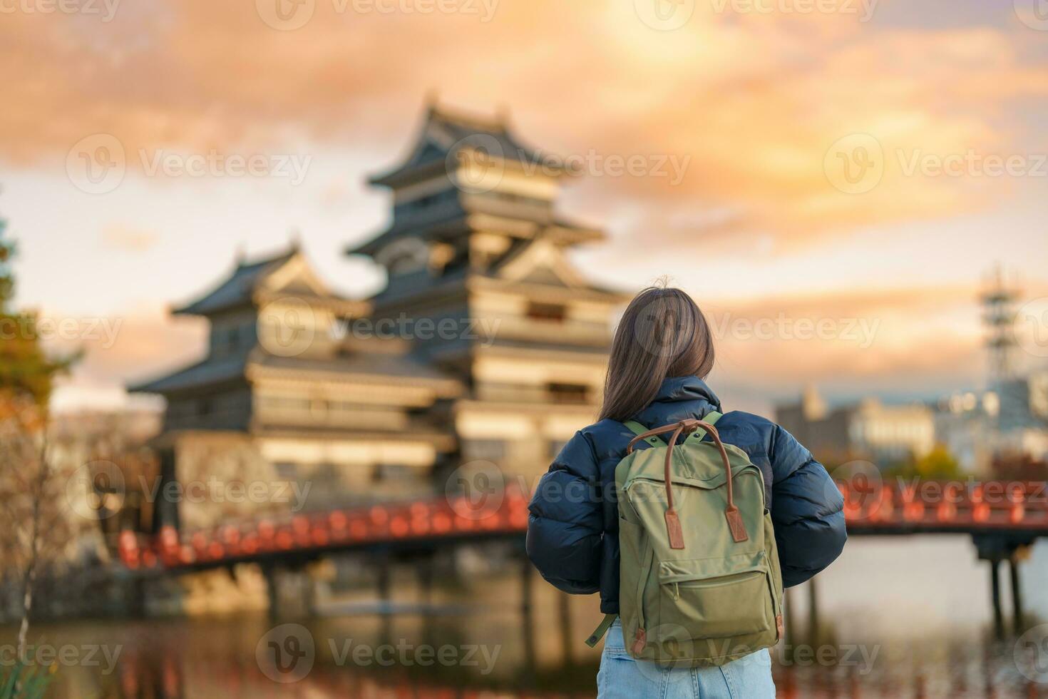 Woman tourist Visiting in Matsumoto, happy Traveler sightseeing Matsumoto Castle or Crow castle. Landmark and popular for tourists attraction in Matsumoto, Nagano, Japan. Travel and Vacation concept photo