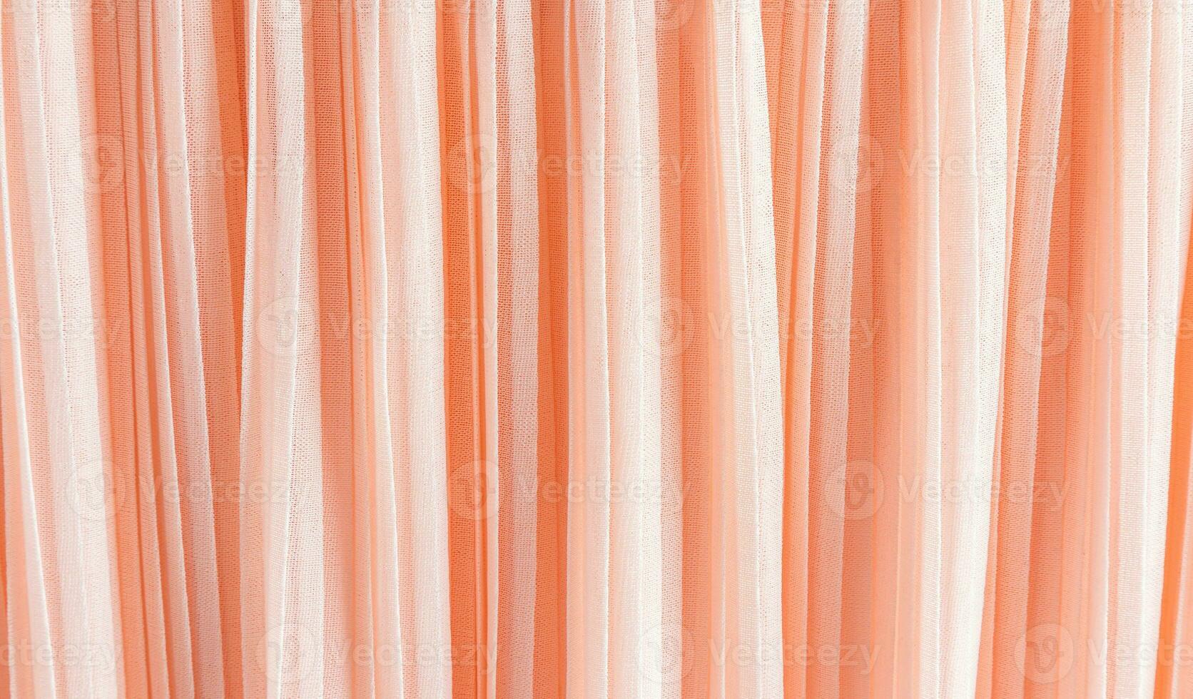 delicate chic textile background of peach color. pleats of chiffon or silk fabric. Abstract background for design. Color of the Year 2024 Peach Fuzz. photo