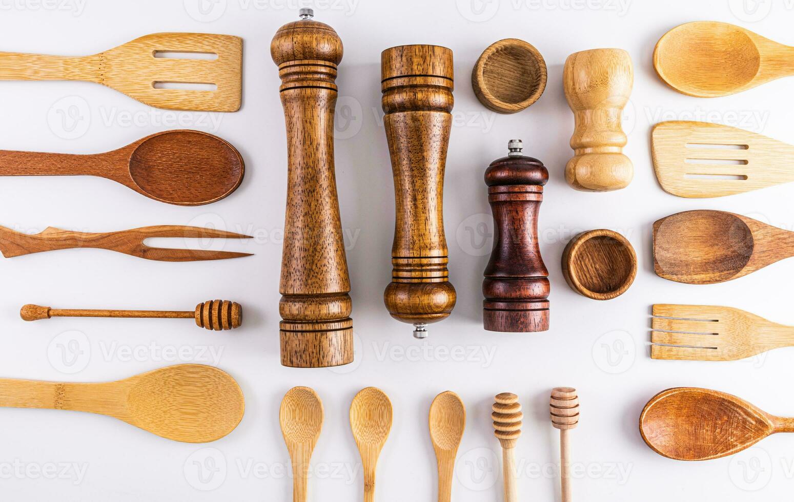 Various kitchen utensils made of natural materials on a light background. Flat laying. Top view. Eco items. photo