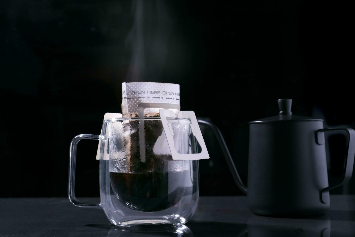 Drip coffee and pour water on the black stone table, soft focus.shallow focus effect. photo