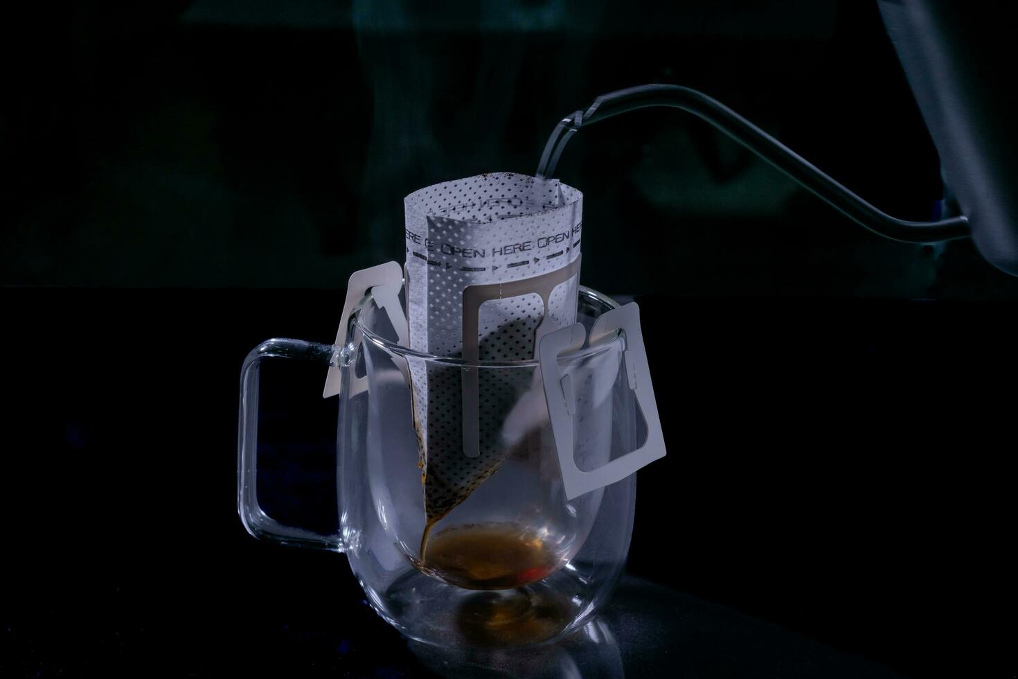 Drip coffee and pour water on the black stone table, soft focus.shallow focus effect. photo