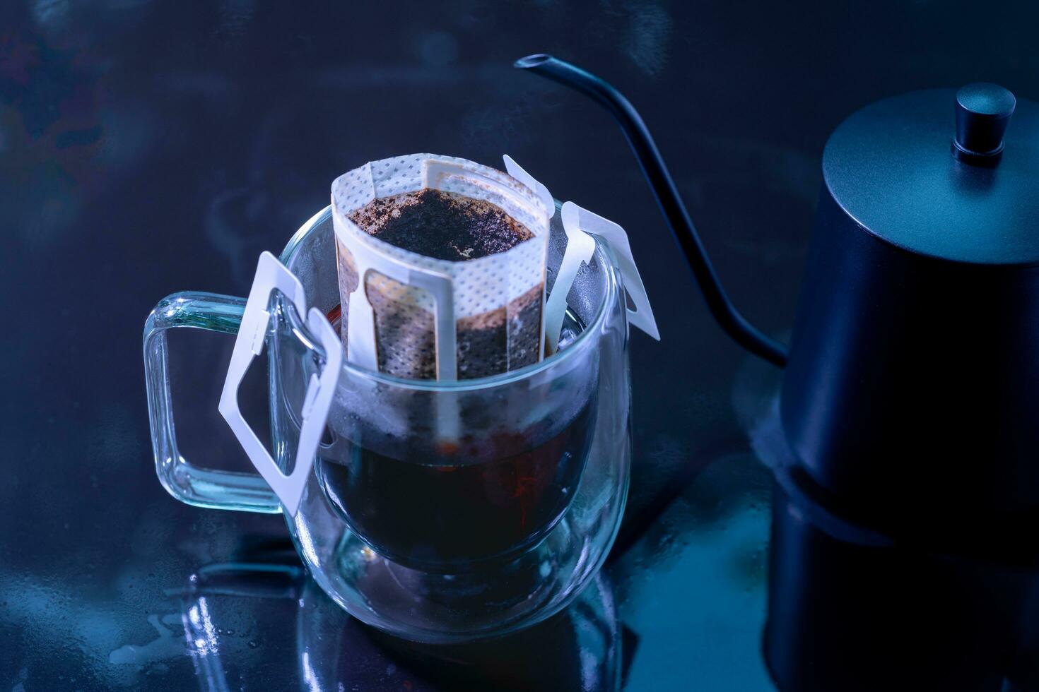 Drip coffee and pour water on the black stone table, soft focus.shallow focus effect. photo