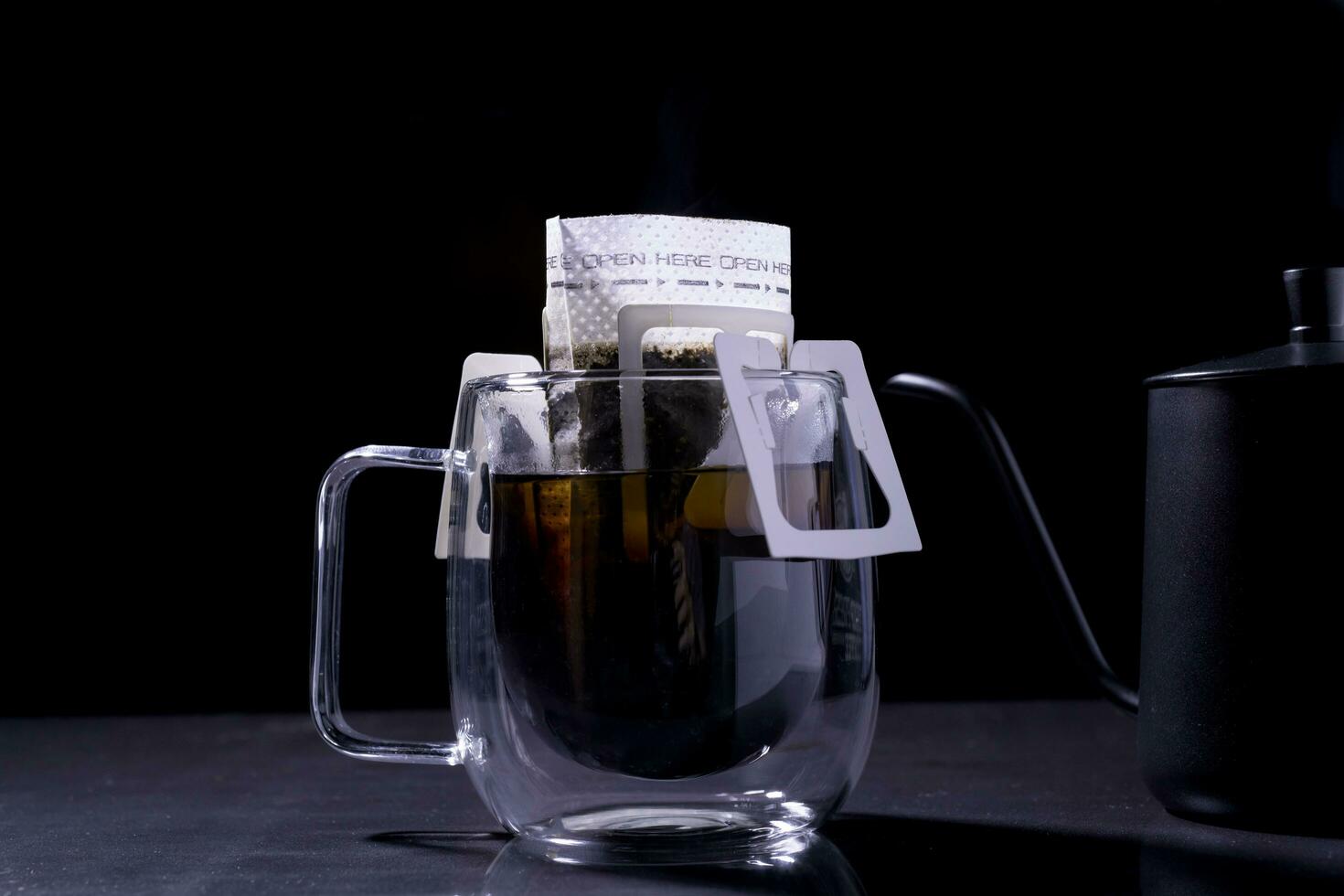 Drip coffee and pour water on the black stone table, soft focus.shallow focus effect. photo