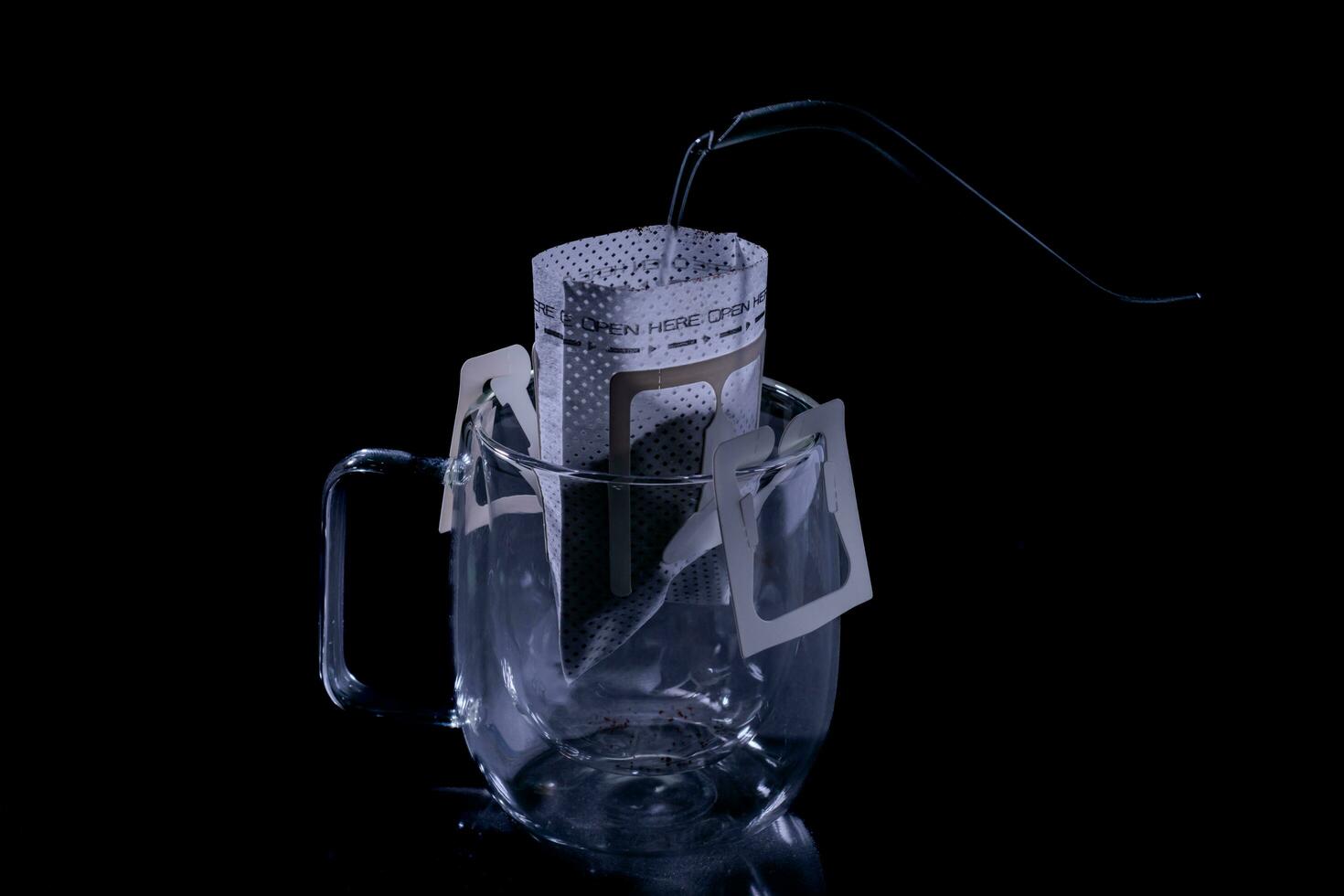 Drip coffee and pour water on the black stone table, soft focus.shallow focus effect. photo