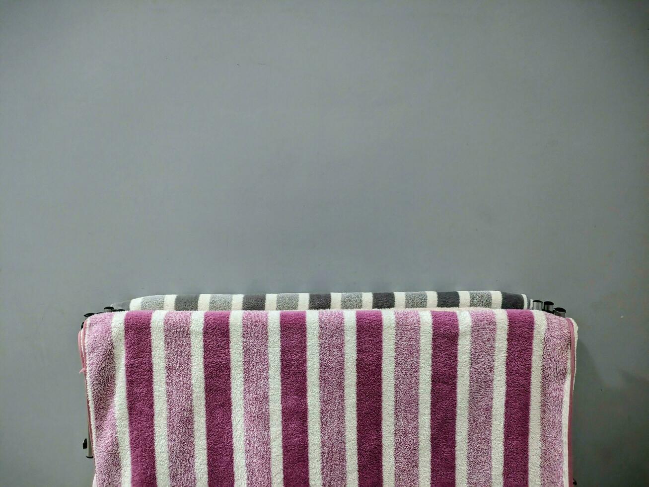 pink and gray bath towels with striped patterns photo