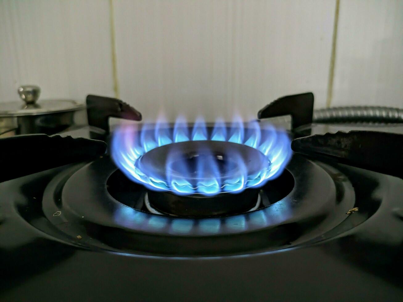 black gas stove with blue flame burning photo