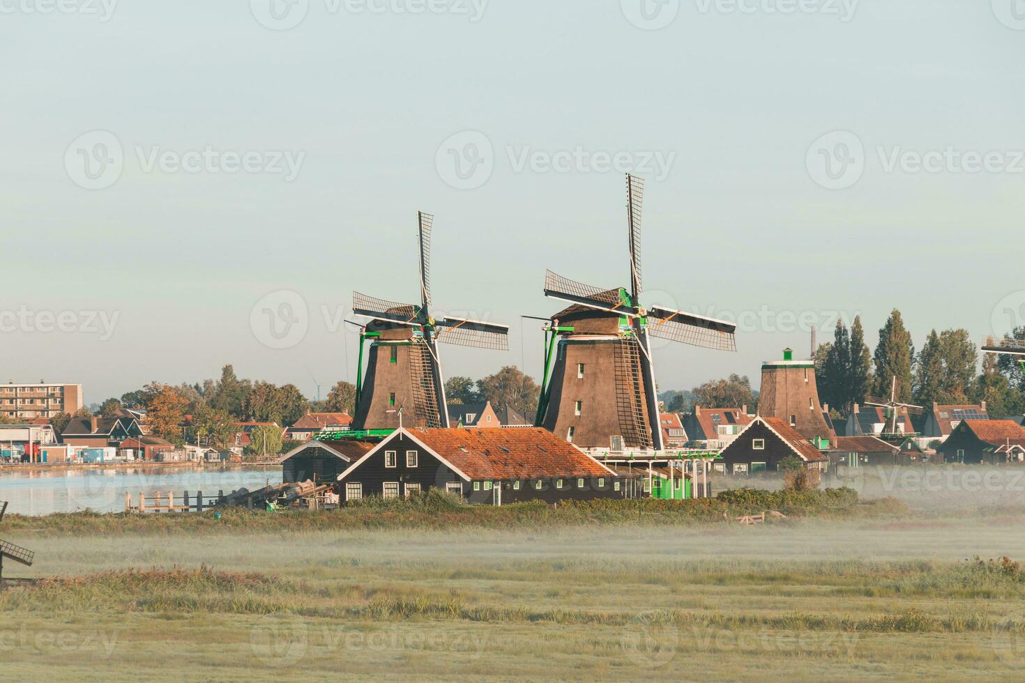 Popular tourist spot Zaanse Schans is near Amsterdam in the west of the Netherlands. Historical, realistic windmills during sunrise. Holland's landmark photo