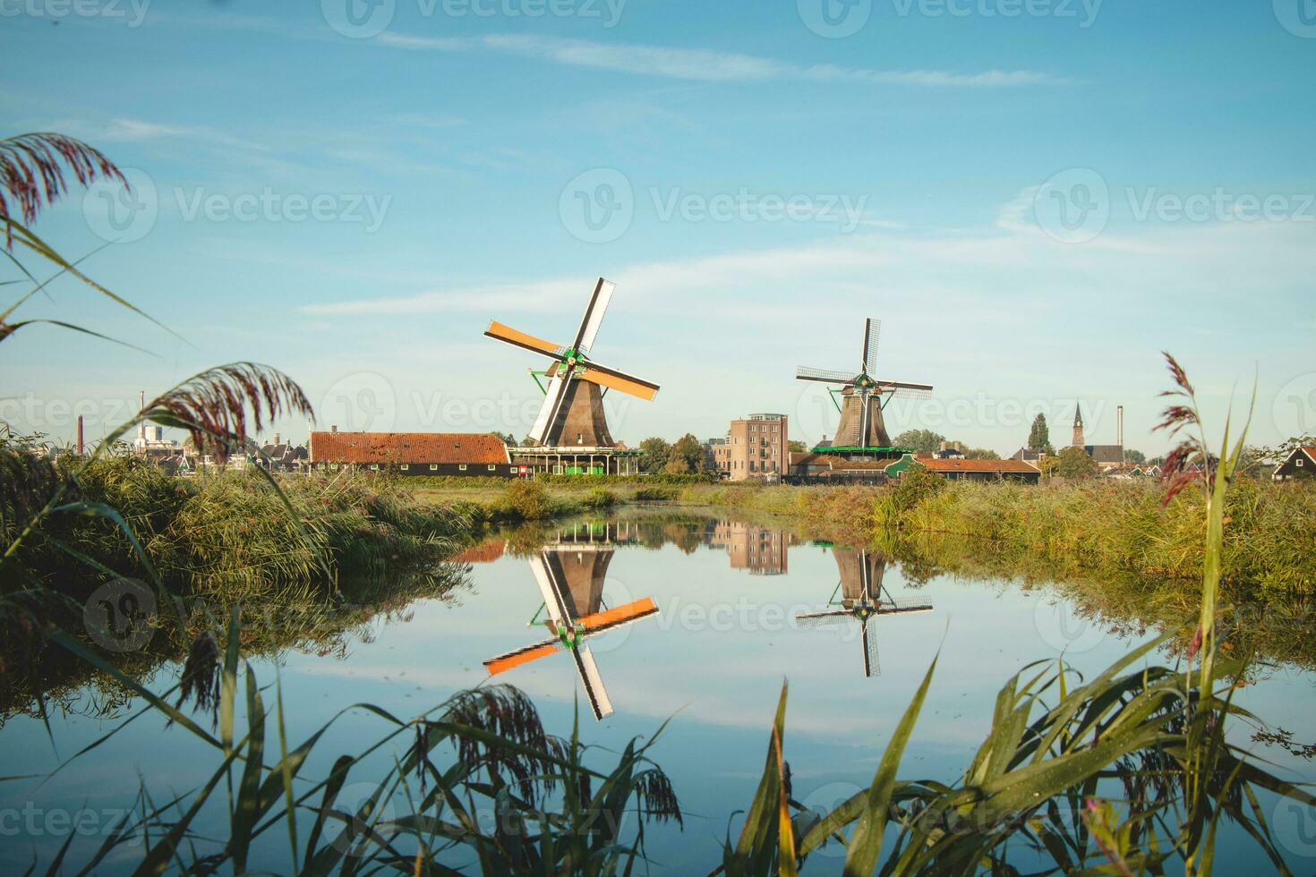 Popular tourist spot Zaanse Schans is near Amsterdam in the west of the Netherlands. Historical, realistic windmills during sunrise. Holland's landmark photo