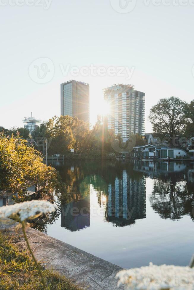 Sunlight streaming through the skyscrapers in Amsterdam, the capital of the Netherlands. Venice of the North photo