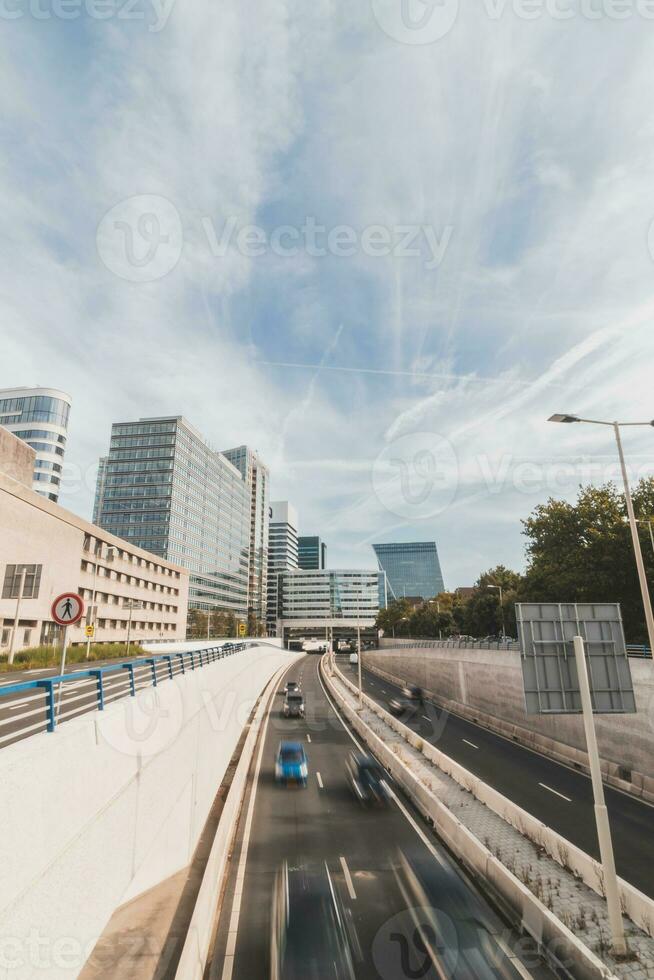 View of the four-lane highway running through Den Haag on a sunny day past the skyscrapers. Traffic in the Netherlands photo