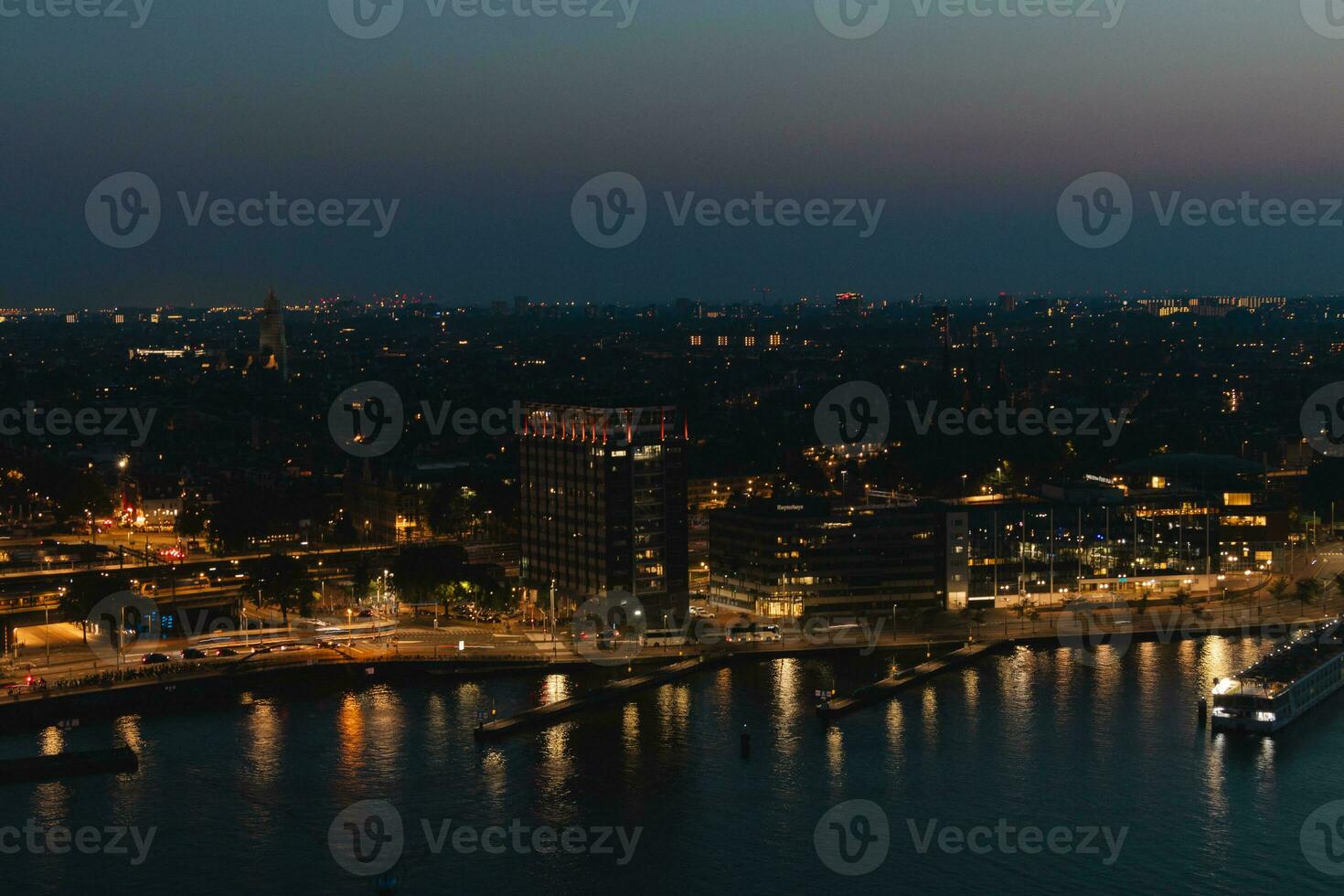 Nightlife in the world's most entertaining city, Amsterdam. Central Station and the city centre under the cover of night. The capital of the Netherlands photo