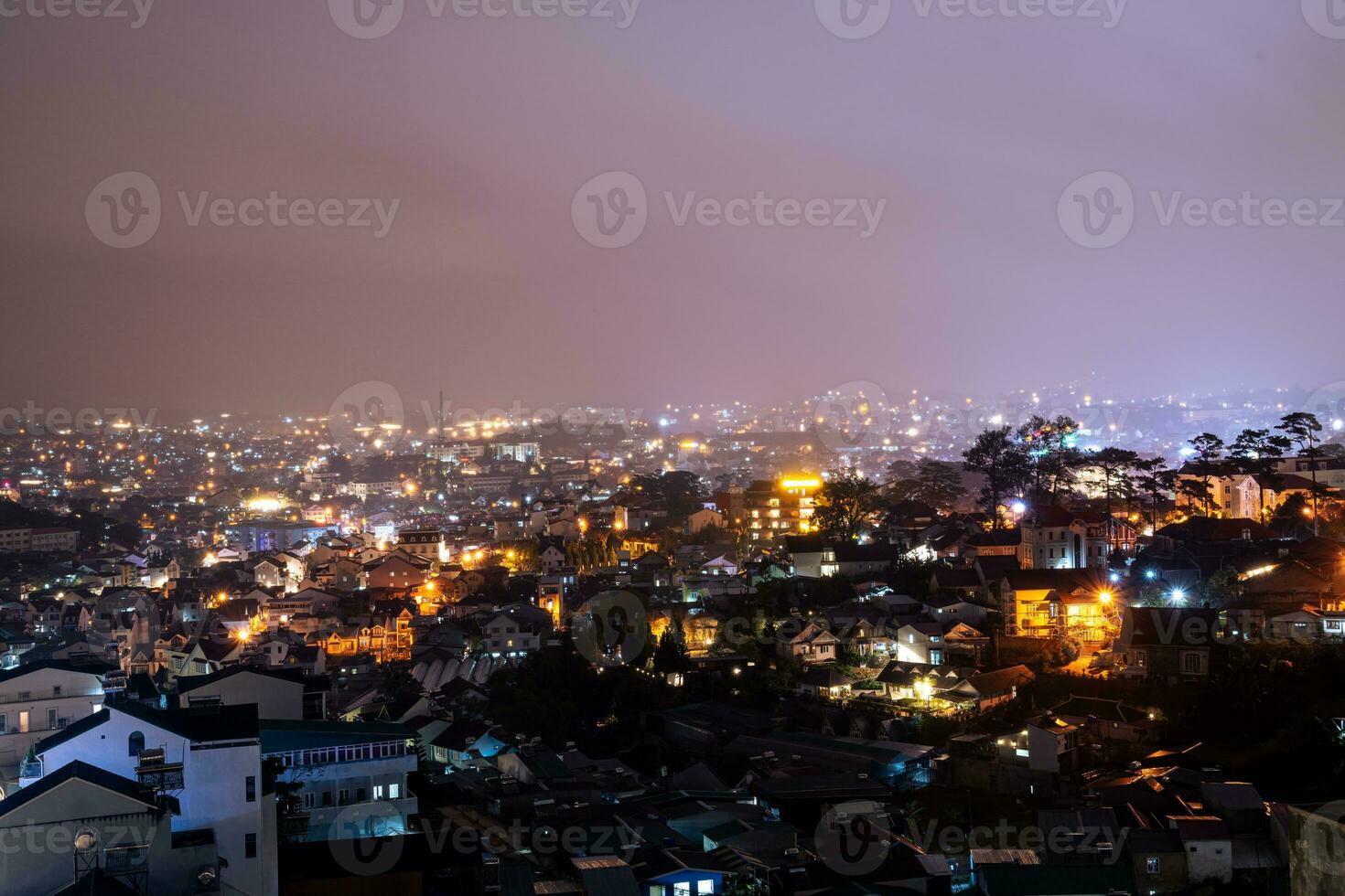 View on roofs in the city of Dalat. Da Lat and the surrounding area is a popular tourist destination of Asia. City with fogs and mountains photo