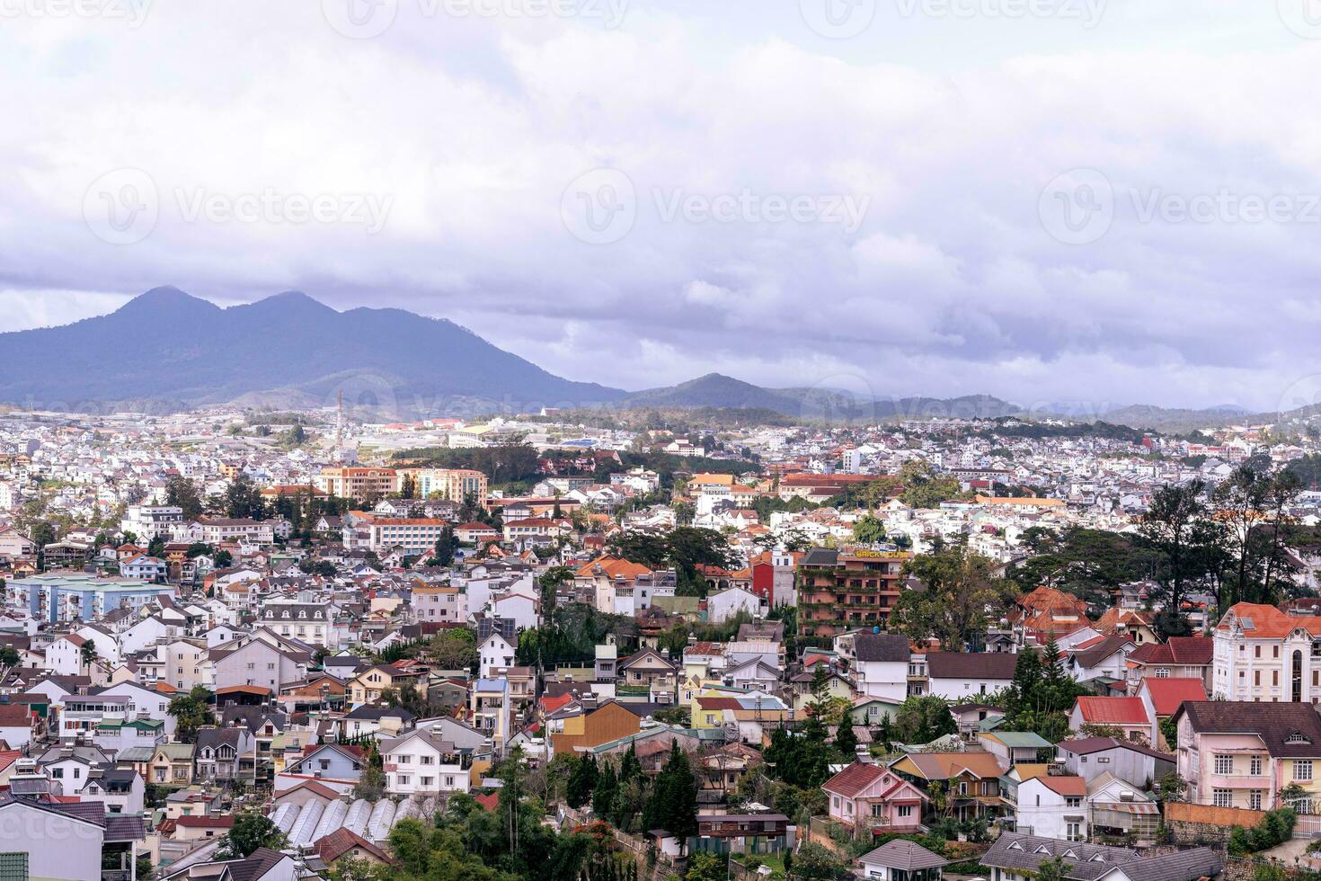 View on roofs in the city of Dalat. Da Lat and the surrounding area is a popular tourist destination of Asia. City with fogs and mountains photo