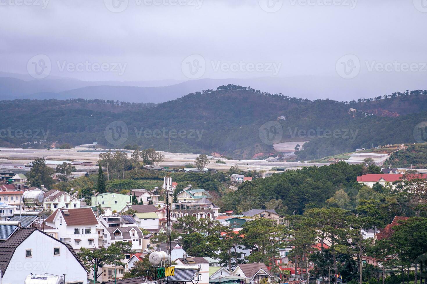 View on roofs in the city of Dalat. Da Lat and the surrounding area is a popular tourist destination of Asia. City with fogs and mountains photo
