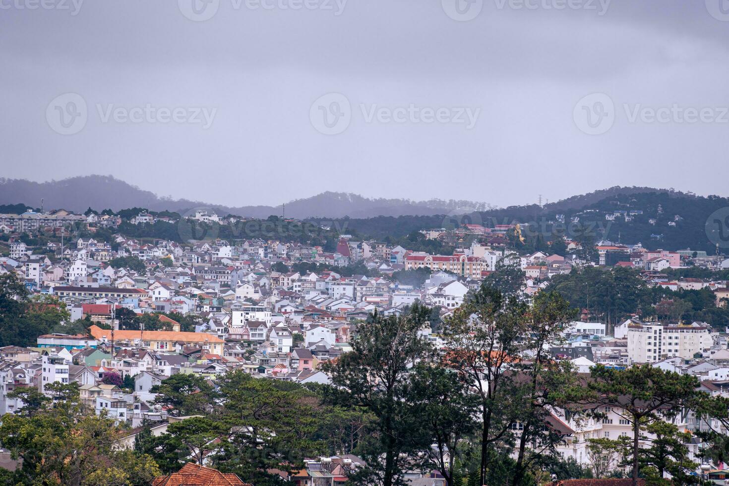 View on roofs in the city of Dalat. Da Lat and the surrounding area is a popular tourist destination of Asia. City with fogs and mountains photo