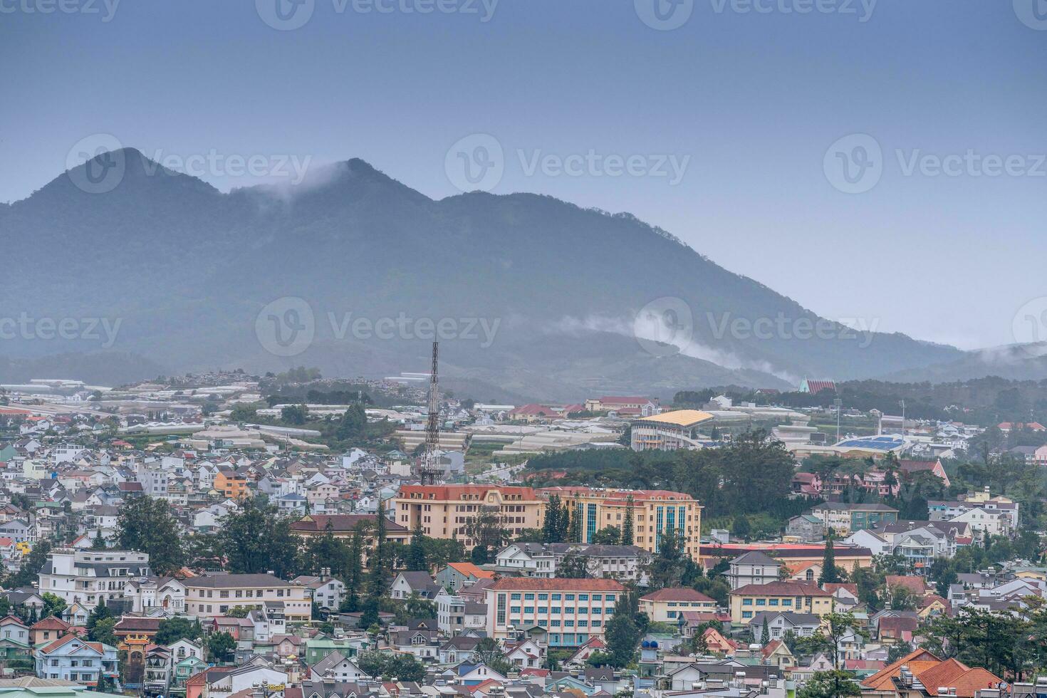 View on roofs in the city of Dalat. Da Lat and the surrounding area is a popular tourist destination of Asia. City with fogs and mountains photo