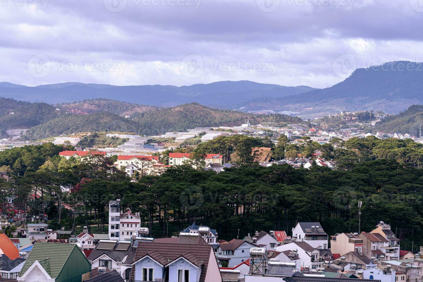 View on roofs in the city of Dalat. Da Lat and the surrounding area is a popular tourist destination of Asia. City with fogs and mountains photo