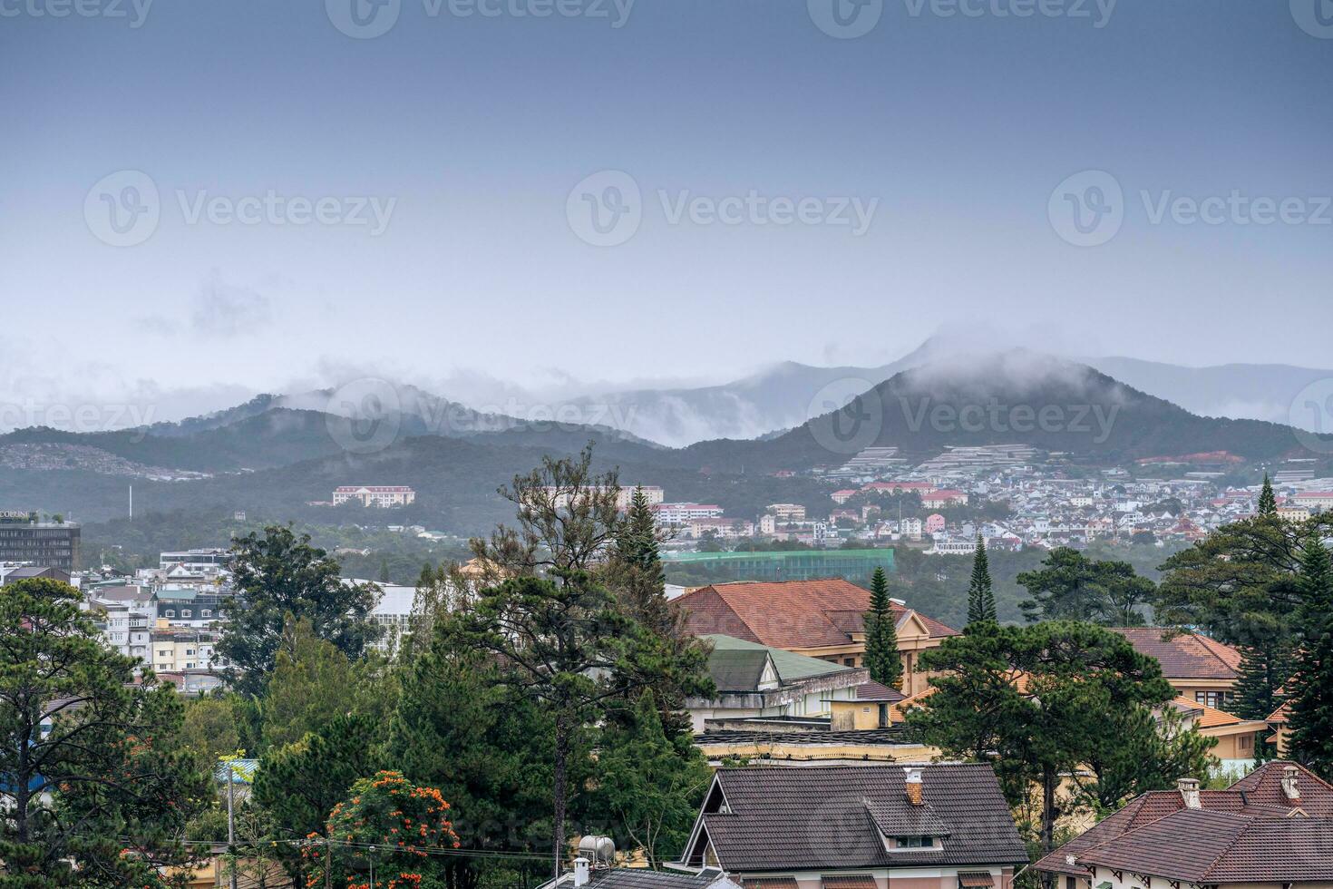 View on roofs in the city of Dalat. Da Lat and the surrounding area is a popular tourist destination of Asia. City with fogs and mountains photo