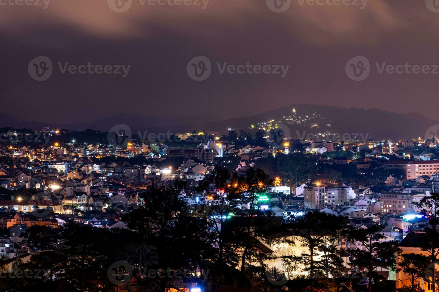 View on roofs in the city of Dalat. Da Lat and the surrounding area is a popular tourist destination of Asia. City with fogs and mountains photo