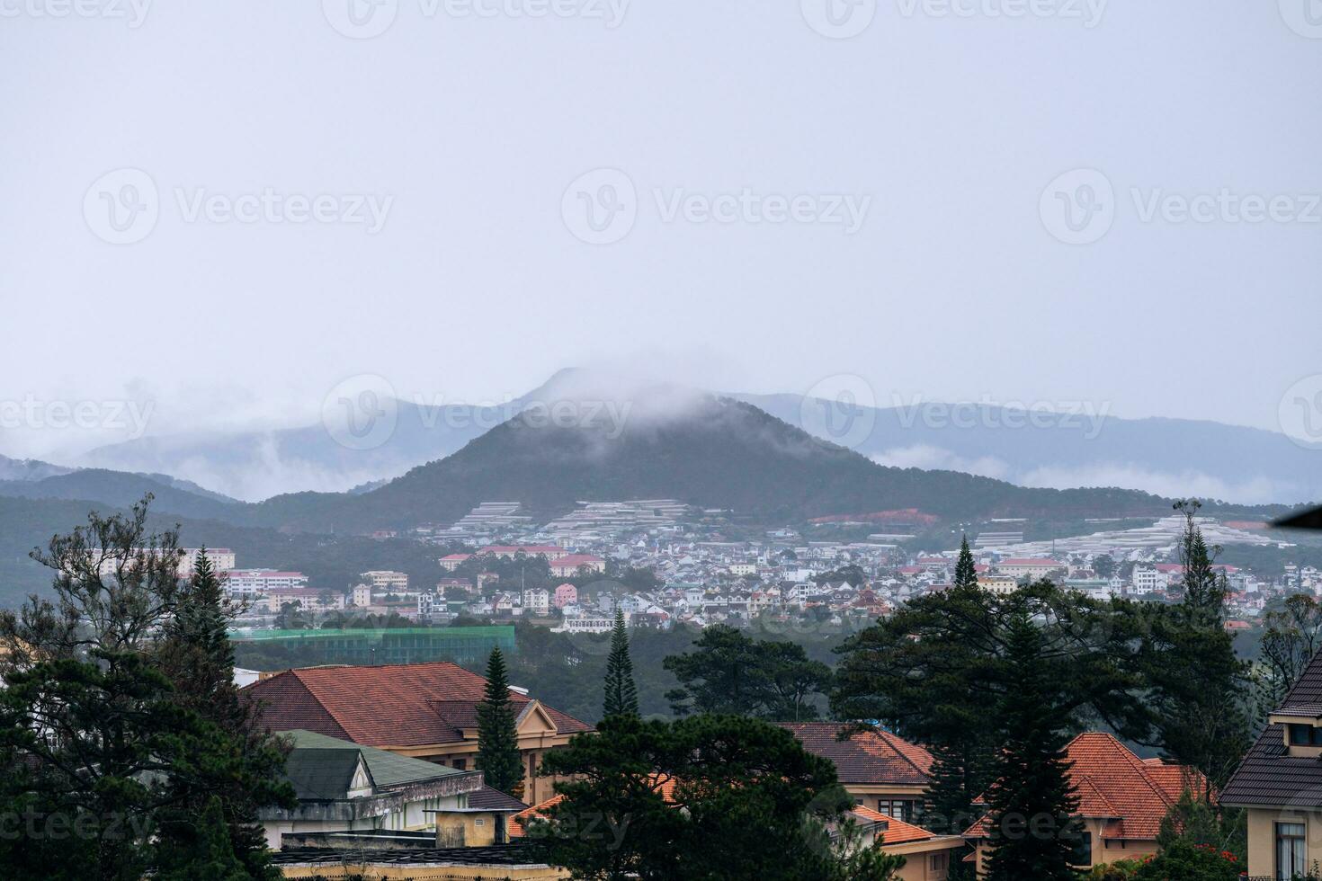View on roofs in the city of Dalat. Da Lat and the surrounding area is a popular tourist destination of Asia. City with fogs and mountains photo