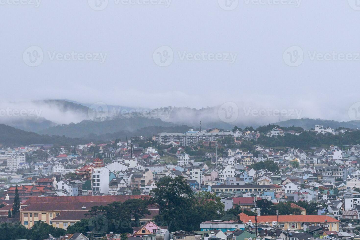 View on roofs in the city of Dalat. Da Lat and the surrounding area is a popular tourist destination of Asia. City with fogs and mountains photo