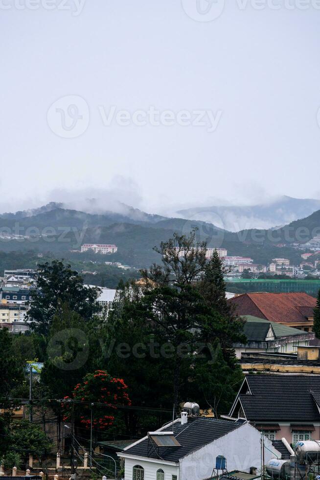 View on roofs in the city of Dalat. Da Lat and the surrounding area is a popular tourist destination of Asia. City with fogs and mountains photo