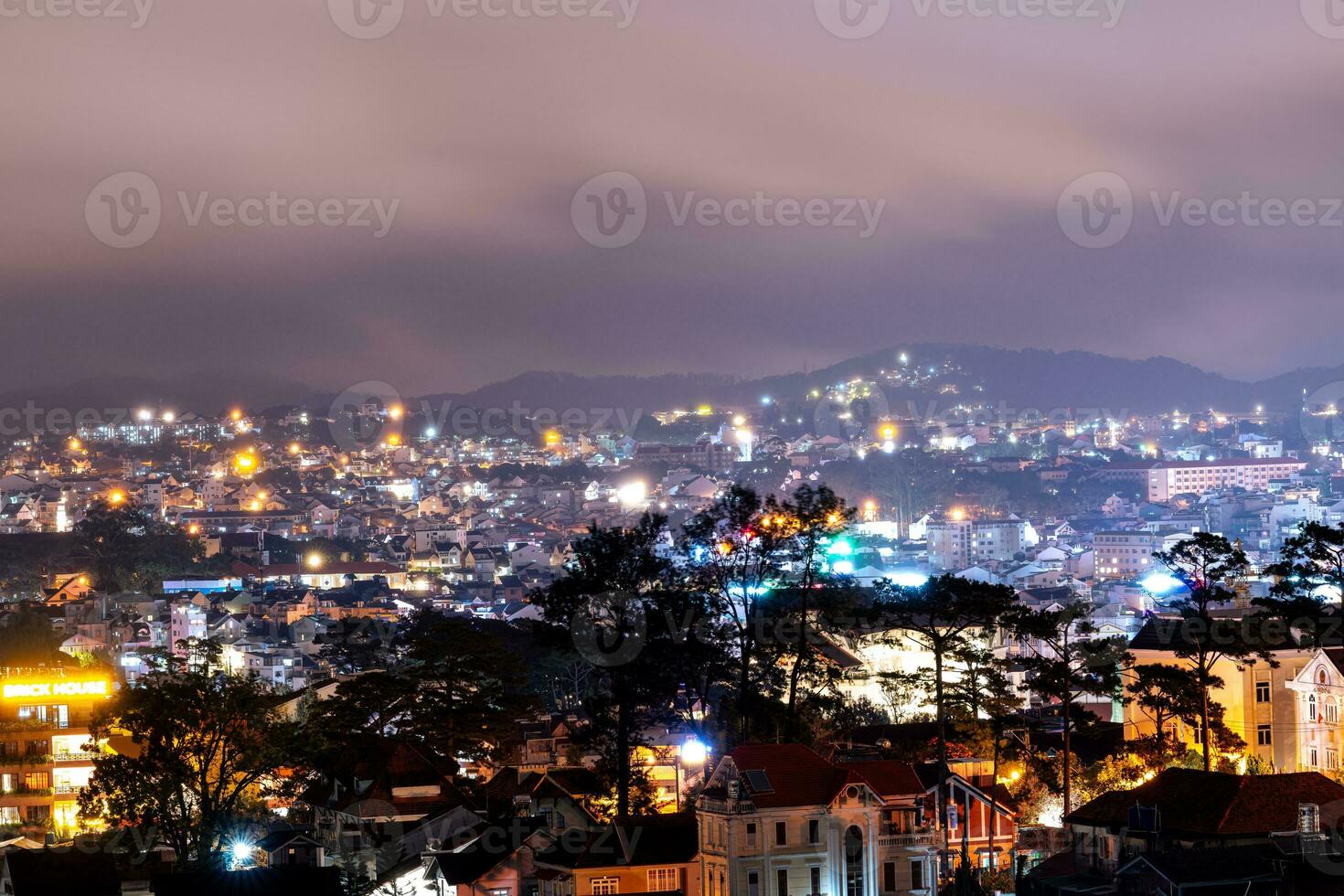 View on roofs in the city of Dalat. Da Lat and the surrounding area is a popular tourist destination of Asia. City with fogs and mountains photo