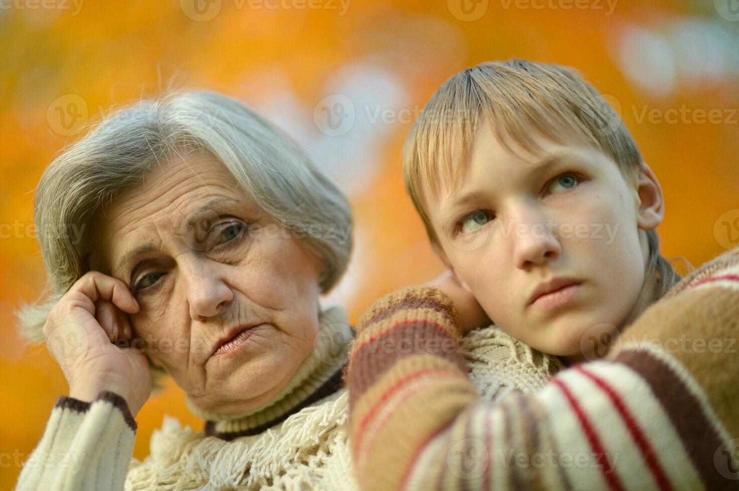 Sad Grandmother with boy in the park photo