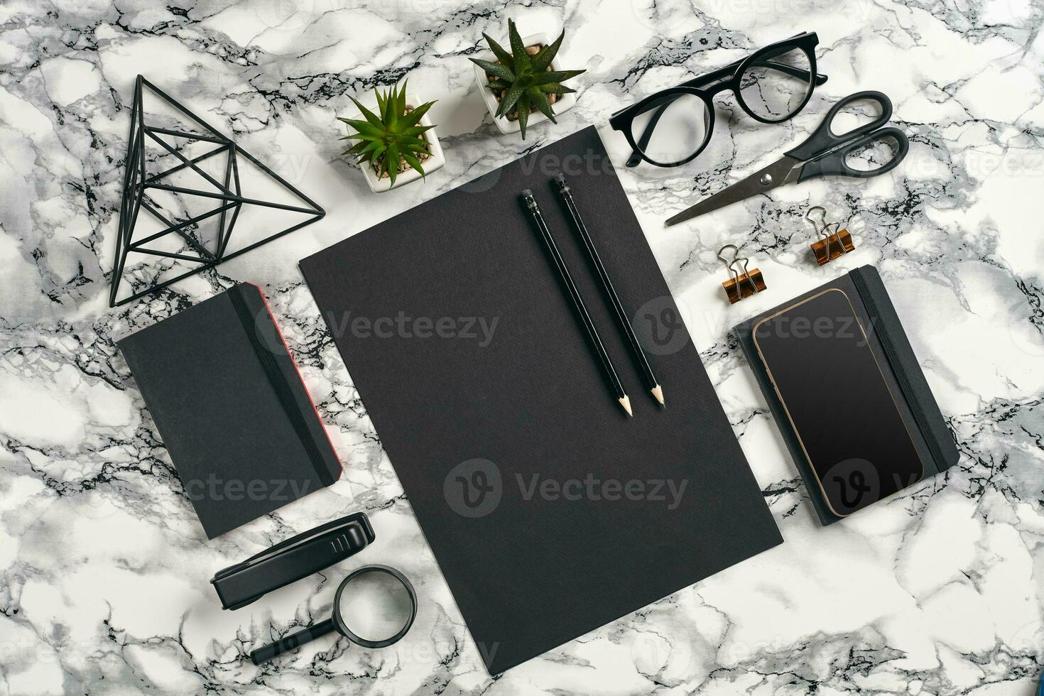 Top view in focus with different office equipment, supplies, stationery. Marble table with copy space. Education, workplace background. Close-up. photo