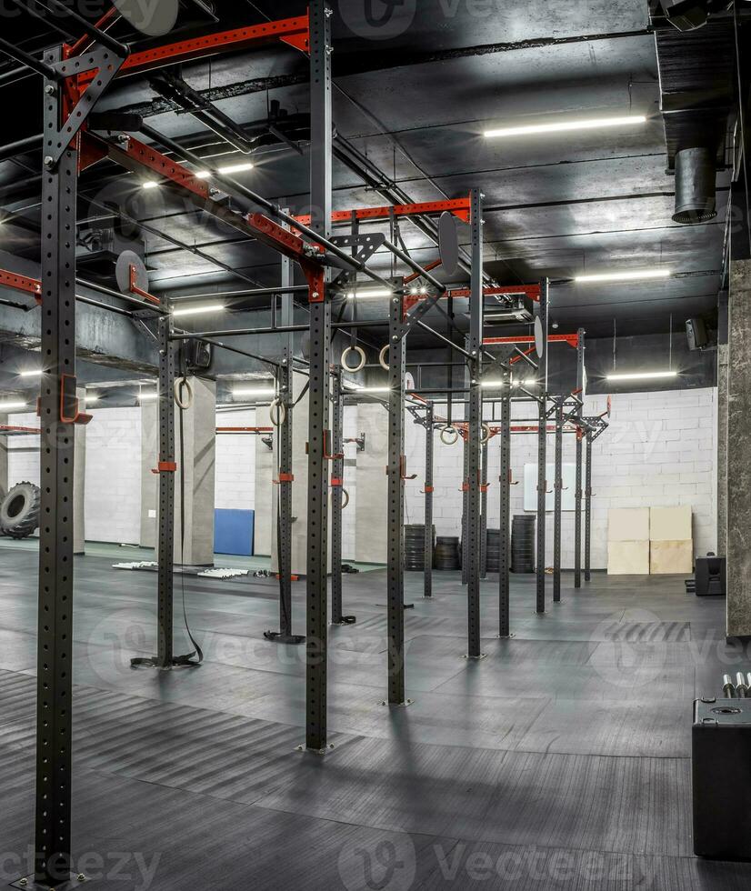 Modern interior of empty gym for crossfit. Special equipment in spacious, well lit room. Horizontal bars, gymnastic rings. Sport, fitness photo