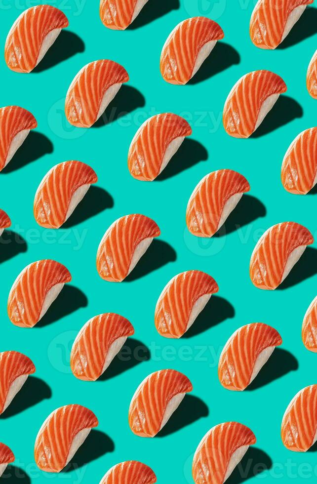 Pattern of nigiri with salmon isolated on turquoise background photo