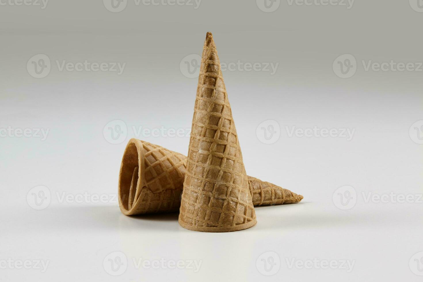 Two empty, medium wafer cones for ice cream isolated on white. Concept of food, treats. Mockup, template for your advertising and design. Close up photo
