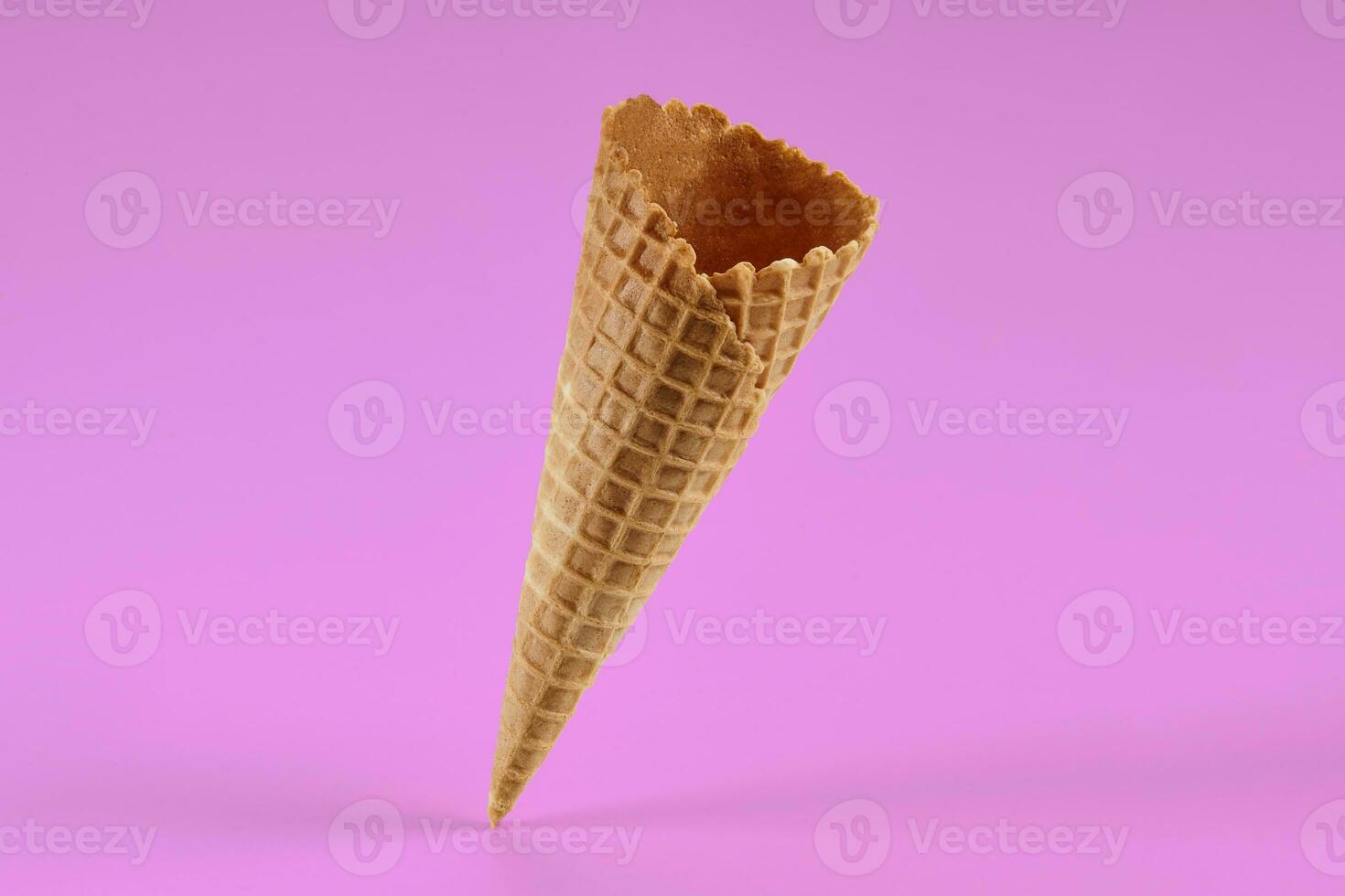 Empty, tasty wafer cone for ice cream against pink background. Concept of food, treats. Mockup, template for your advertising and design. Close up photo