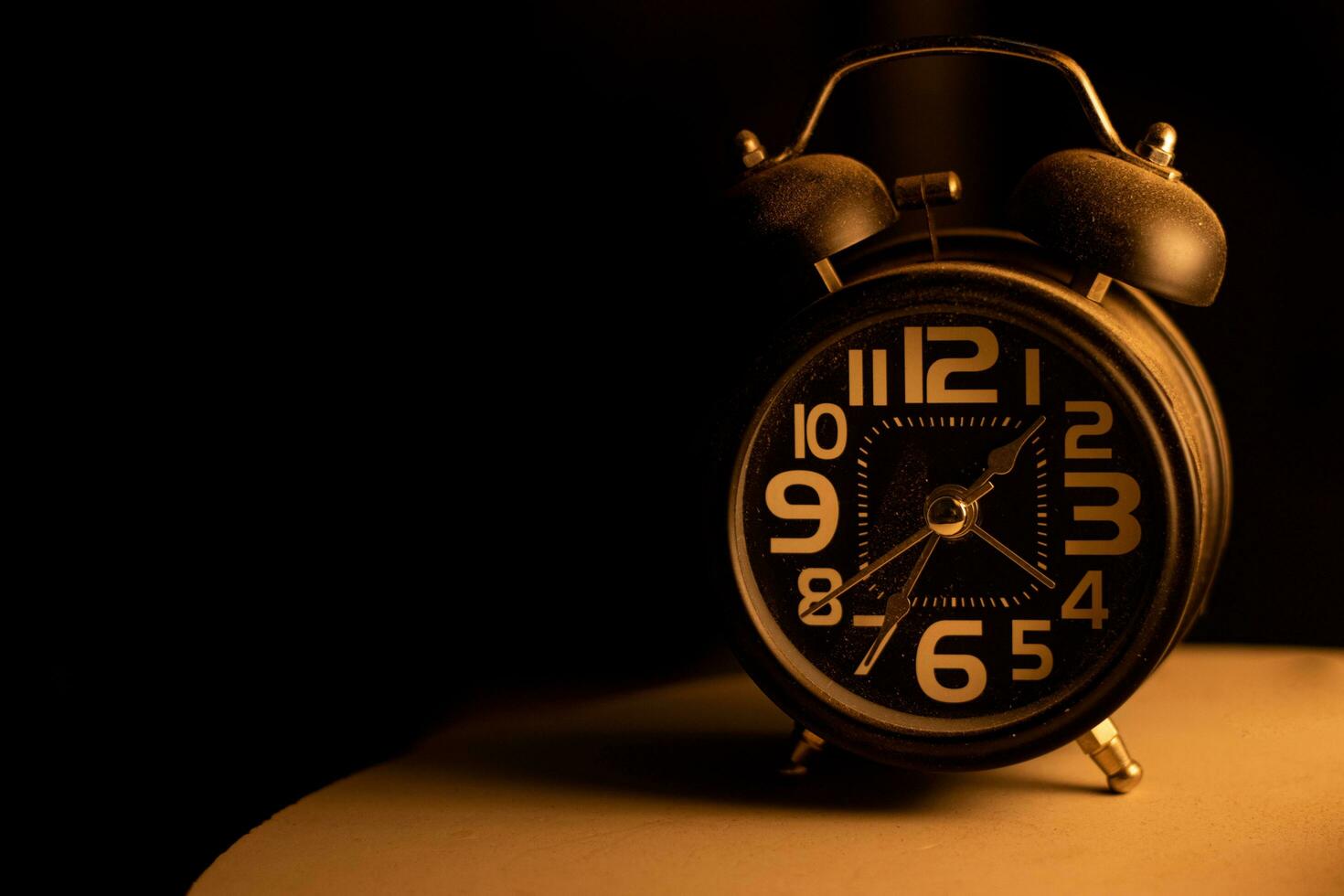 Close-up of a black alarm clock , early morning photo