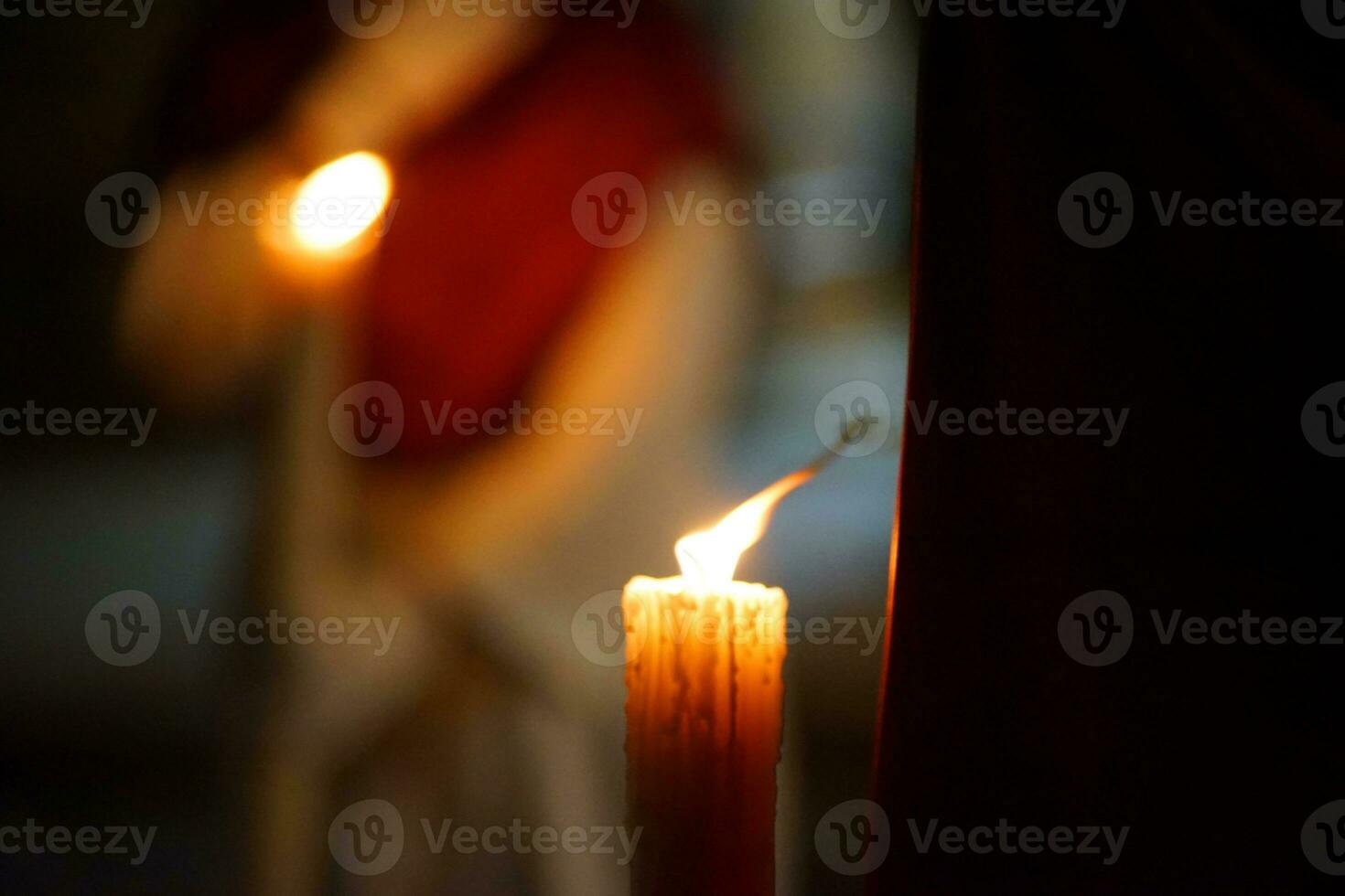 Closeup of a Nazarene and his candle in procession photo
