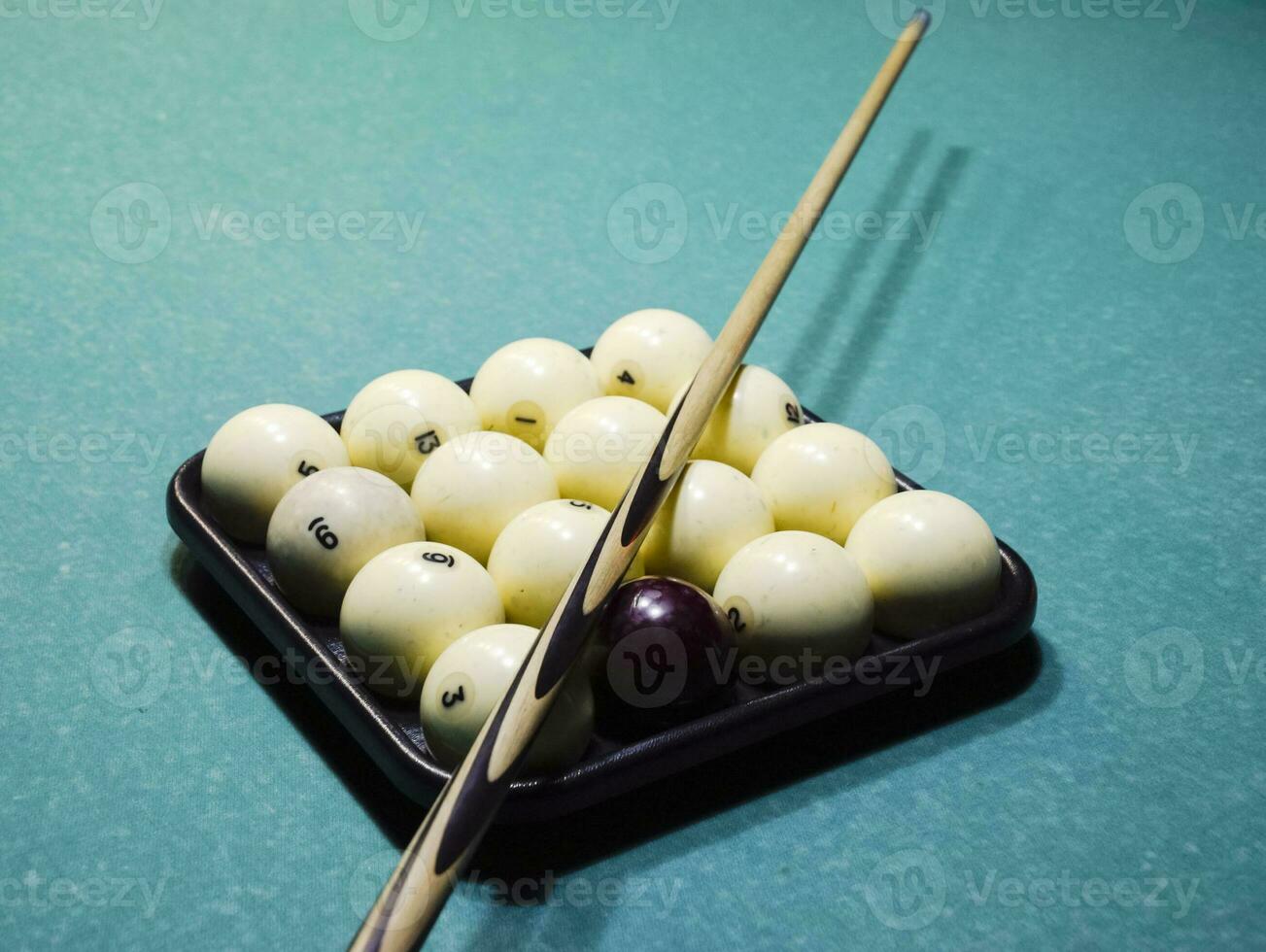 Billiards, billiard table, balls and cue. Balls in the tray and photo