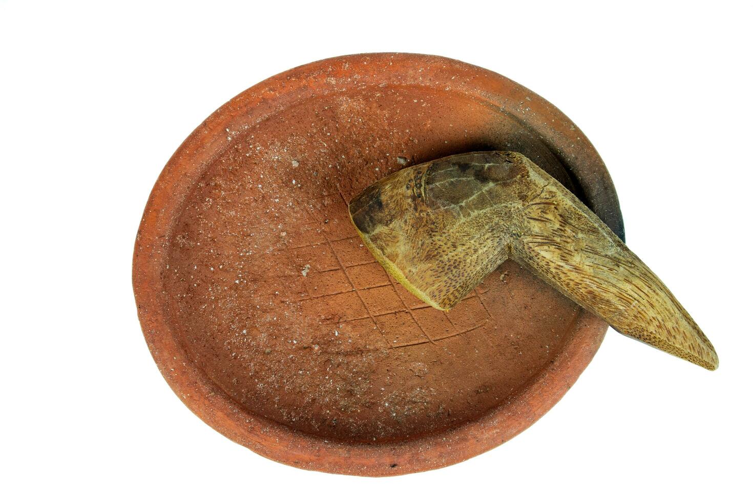 Traditional mortar and pestle made of clay and wood on a white background photo