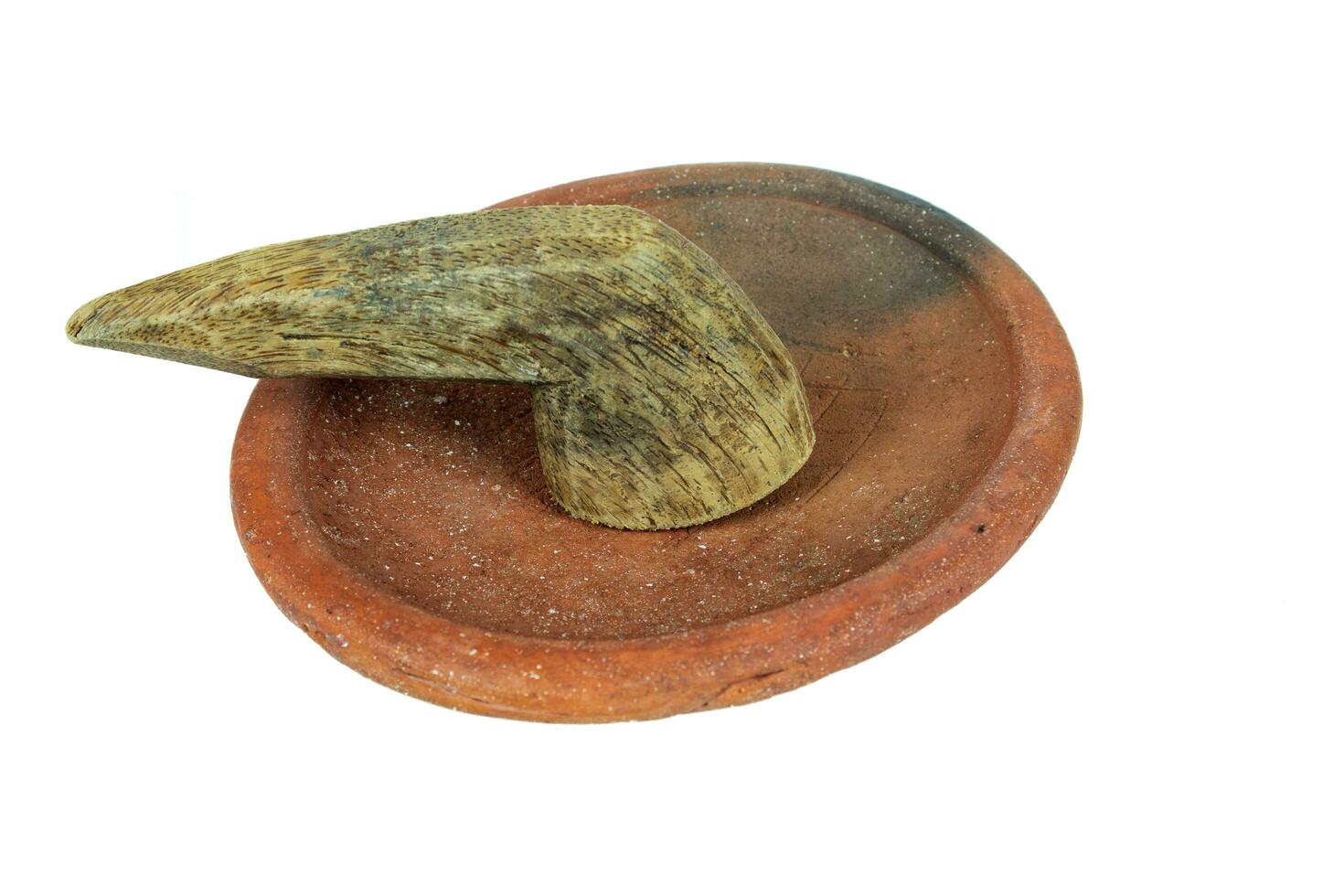 Traditional mortar and pestle made of clay and wood on a white background photo