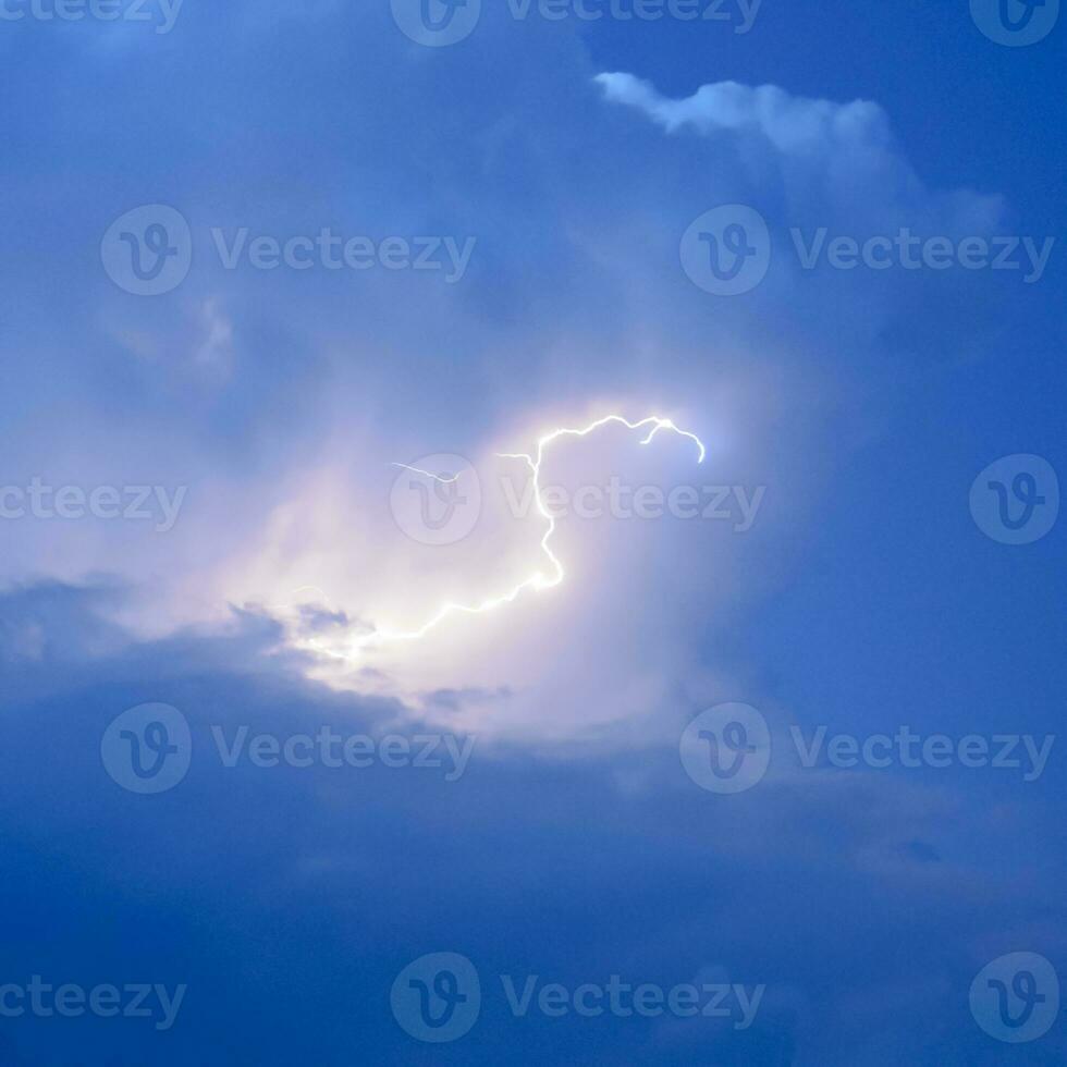 Lightnings in storm clouds. Peals of a thunder and the sparkling photo