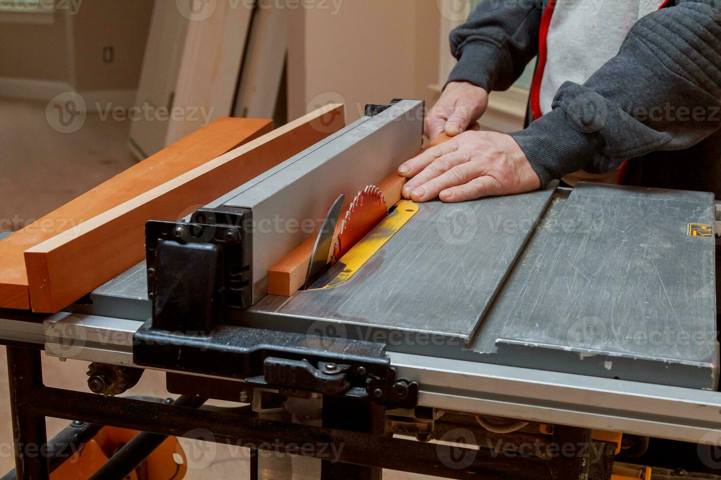 Circular saw cutting wooden plank close-up blade photo