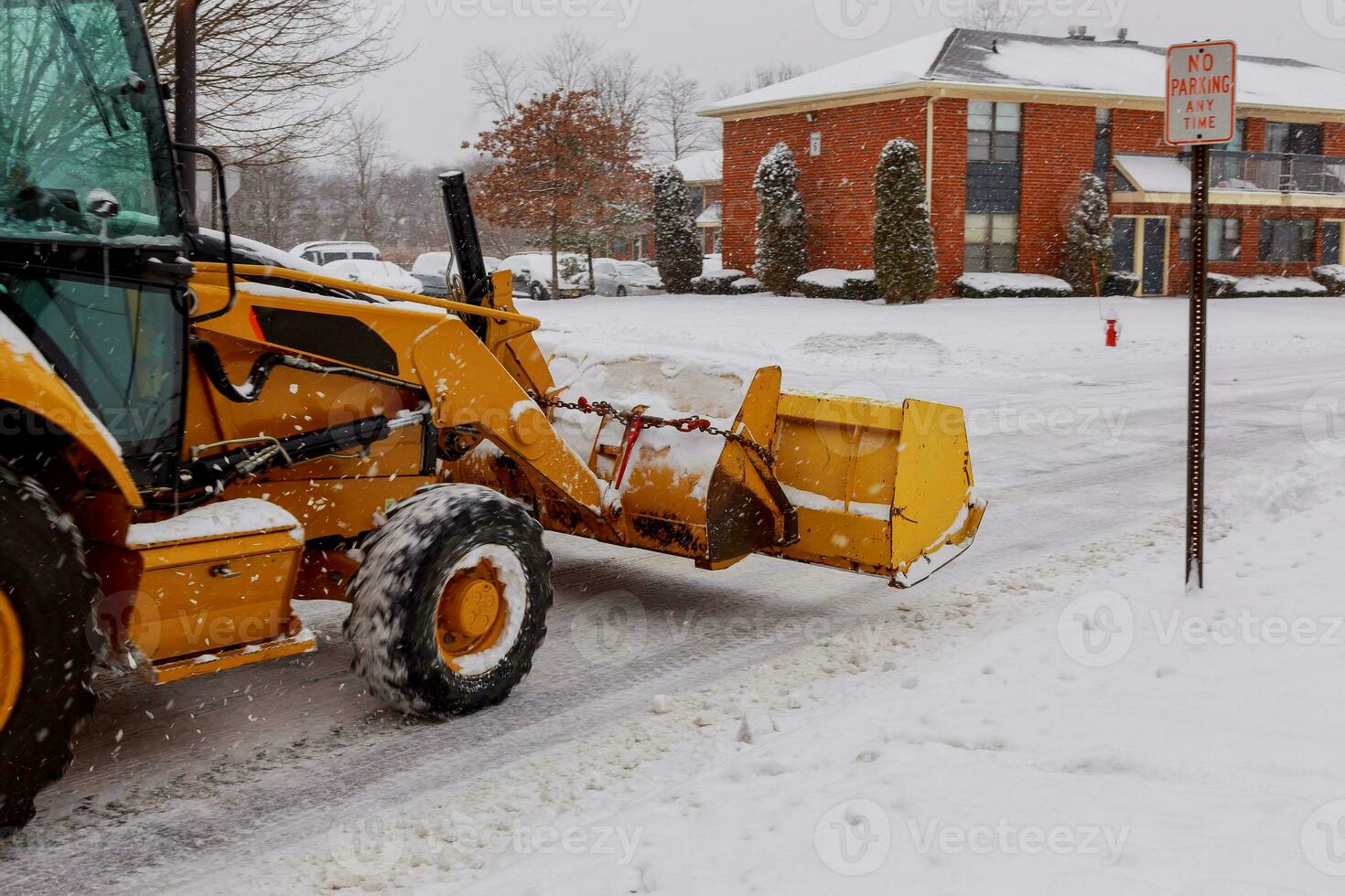 Snow plow doing removal after a blizzard photo