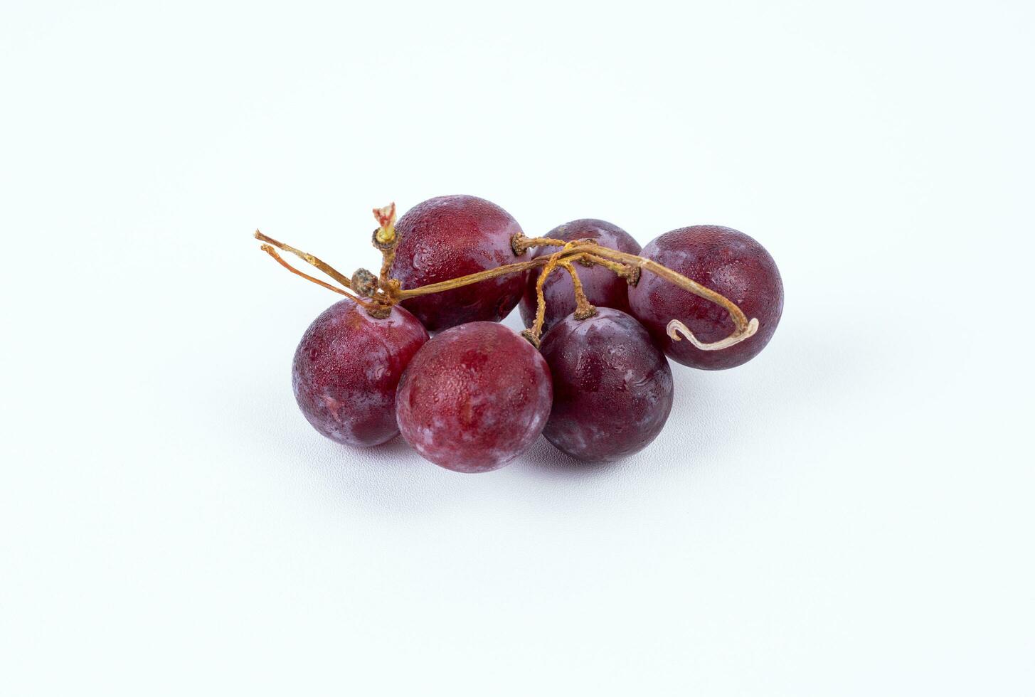 Red fresh grapes isolated on white background photo