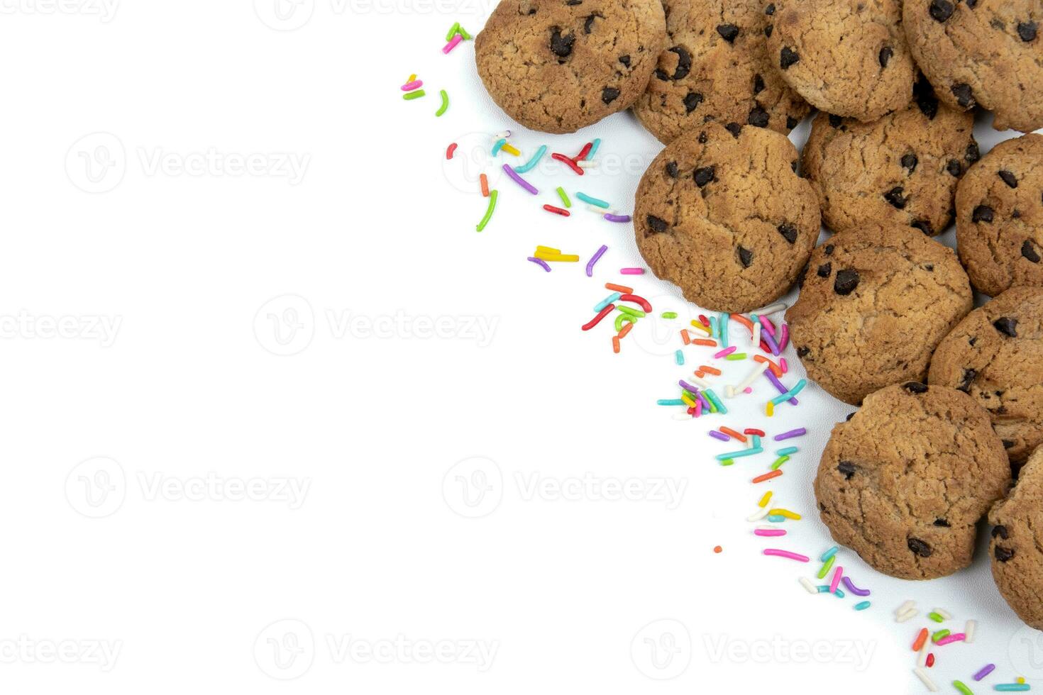 Chocolate chip cookies and colorful sprinkles on a white background photo