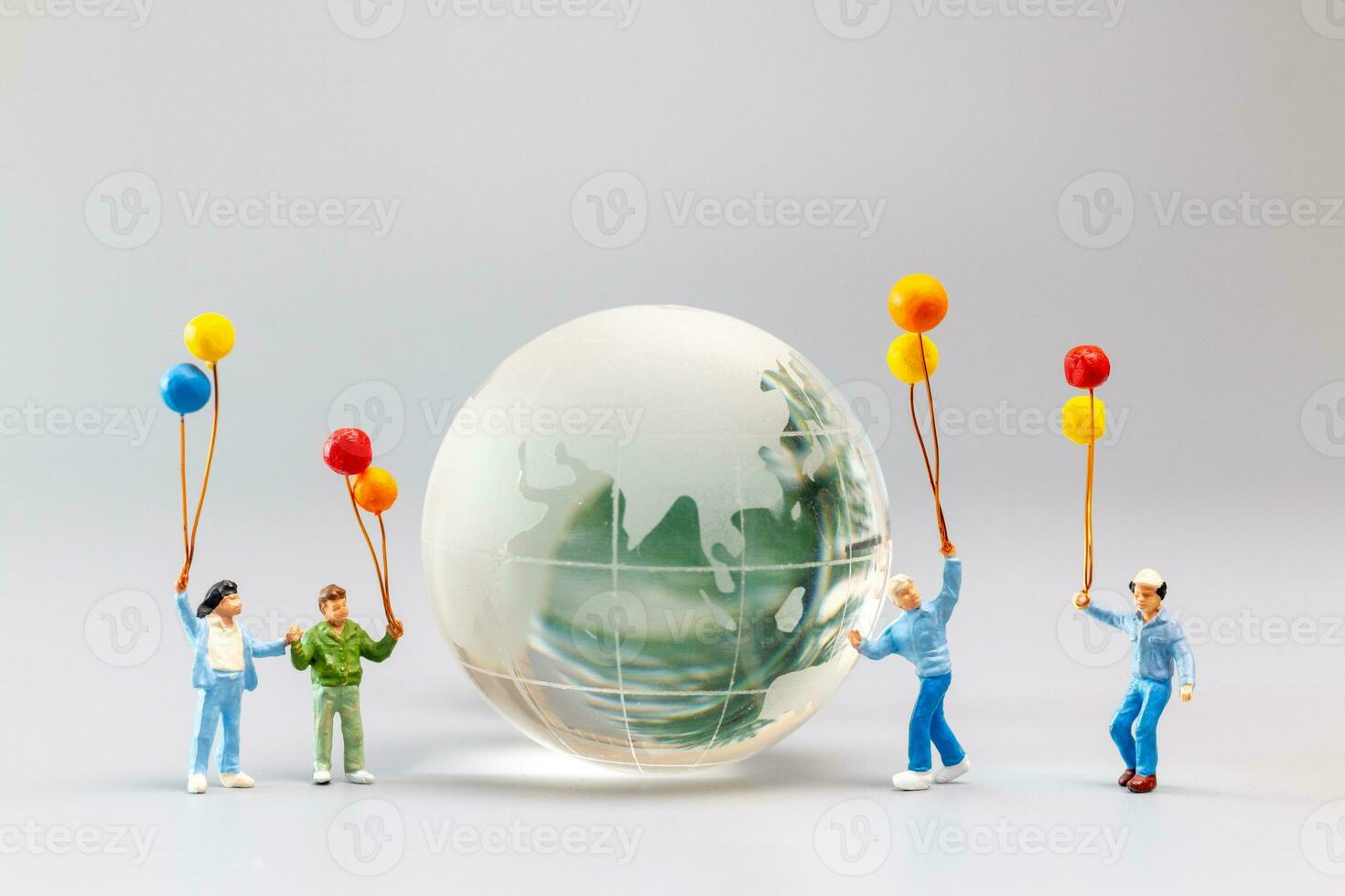 A joyful family with a balloon encircling a crystal globe  and the conncept of World Earth Day photo