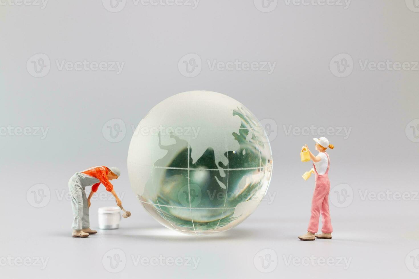 Painters are polishing a crystal globe, and the concept of World Earth Day photo