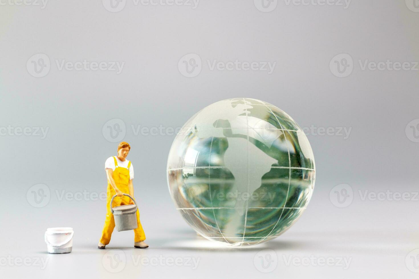 Painters are polishing a crystal globe, and the concept of World Earth Day photo