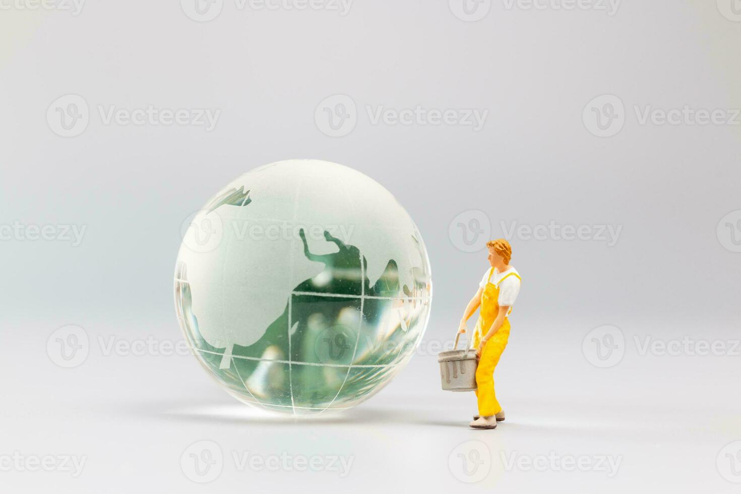 Painters are polishing a crystal globe, and the concept of World Earth Day photo