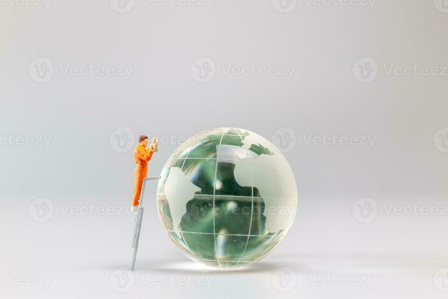 Painters are polishing a crystal globe, and the concept of World Earth Day photo