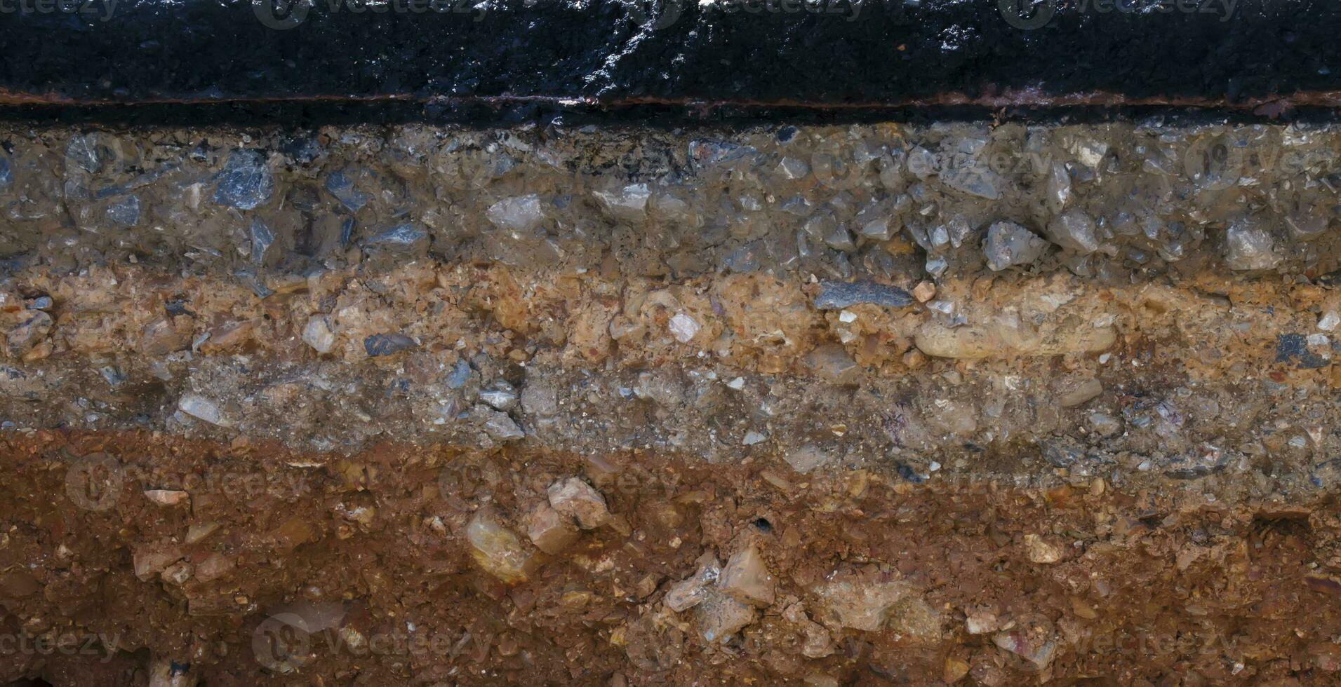 The curb erosion from storms. To indicate the layers of soil and rock. photo