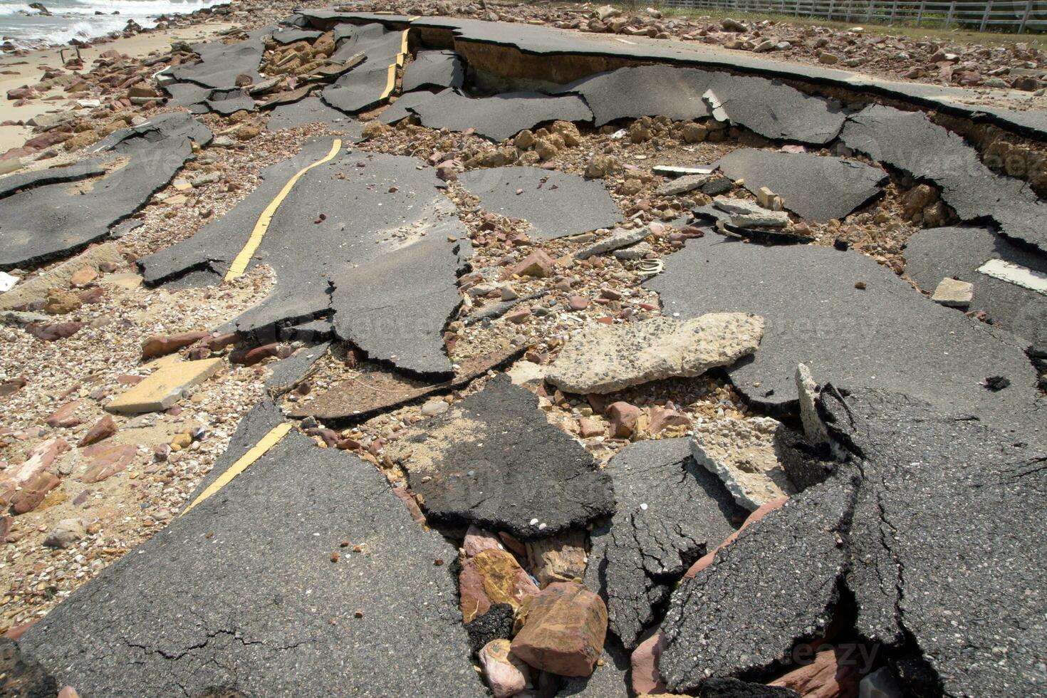 Road erosion caused by waves and severe storms. photo